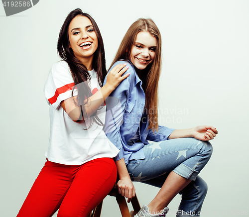 Image of best friends teenage girls together having fun, posing emotional on white background, besties happy smiling, lifestyle people concept, blond and brunette multi nations 