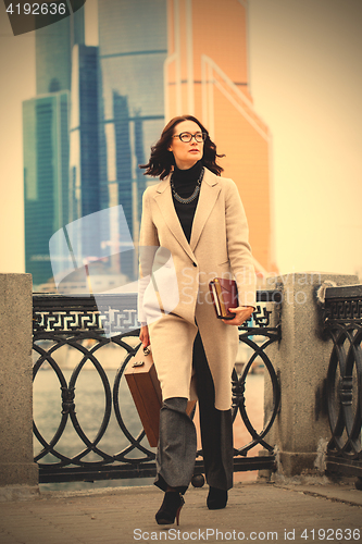 Image of beautiful business woman in a bright coat