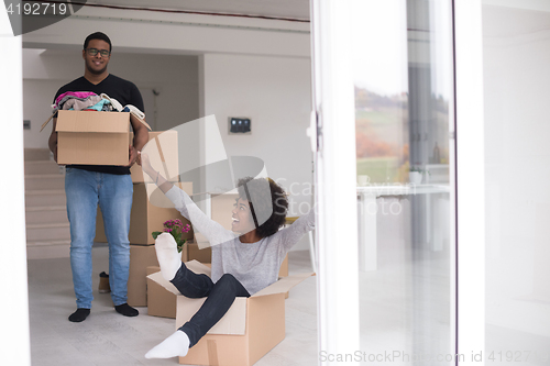 Image of African American couple  playing with packing material