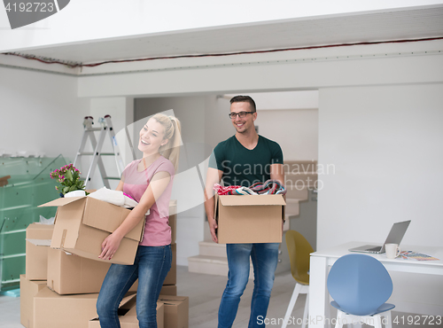 Image of young couple moving into a new home