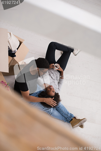 Image of African American couple relaxing in new house