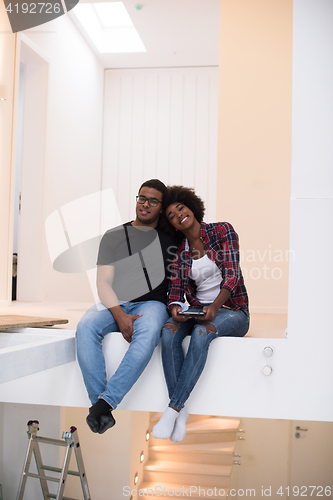 Image of couple having break during moving to new house