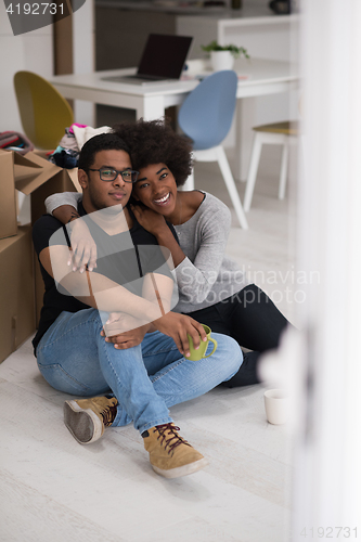 Image of African American couple relaxing in new house