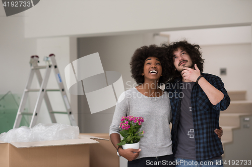 Image of multiethnic couple moving into a new home