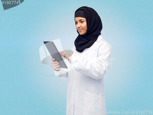 Image of muslim female doctor in hijab with tablet pc