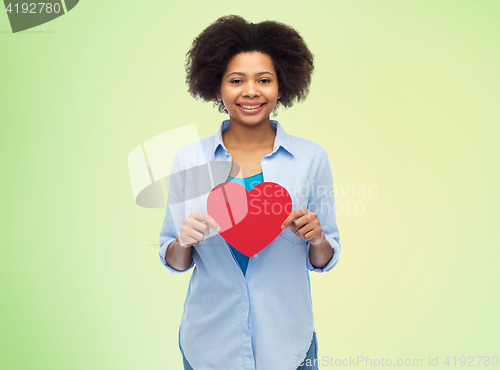 Image of happy african american woman with red heart shape