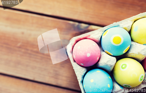 Image of close up of colored easter eggs in egg box