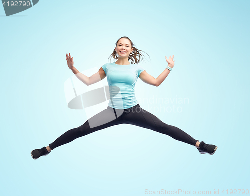 Image of happy smiling sporty young woman jumping in air