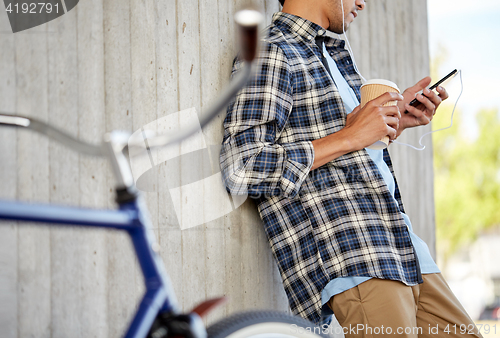 Image of man with earphones and smartphone listening music