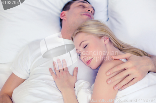 Image of happy couple sleeping in bed