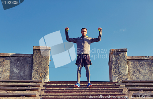 Image of happy man on stadium stair