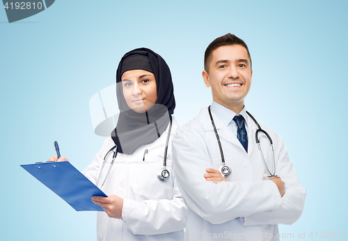 Image of happy doctors with clipboard and stethoscopes