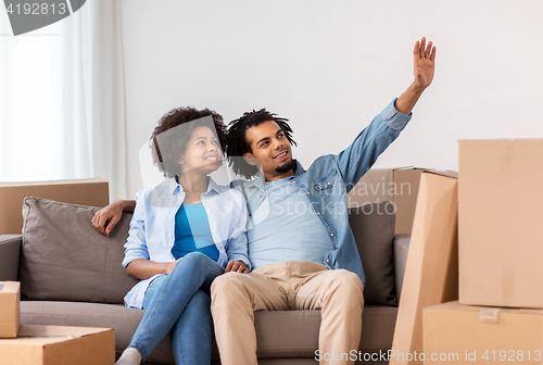 Image of happy couple with boxes moving to new home