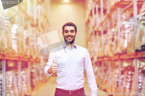 Image of happy man at warehouse showing thumbs up gesture