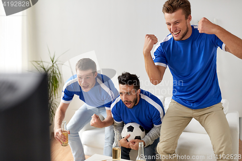 Image of friends or football fans watching soccer at home