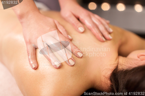 Image of close up of woman having back massage at spa