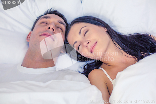 Image of happy couple sleeping in bed