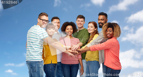 Image of international group of happy people holding hands