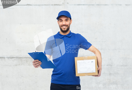 Image of happy delivery man with parcel box and clipboard