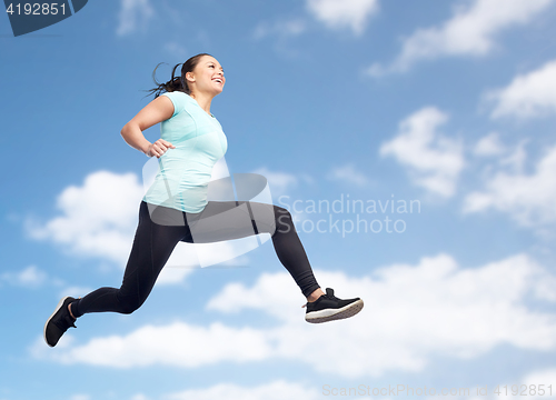 Image of happy smiling sporty young woman jumping in air