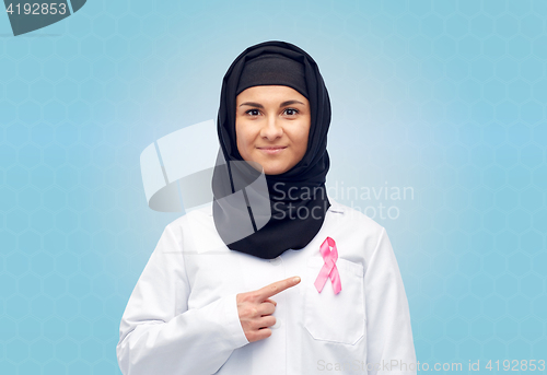 Image of muslim doctor with breast cancer awareness ribbon