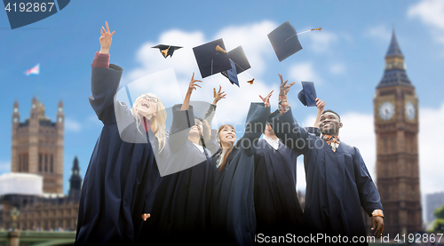 Image of happy students throwing mortarboards up