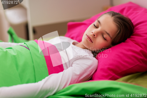Image of girl sleeping in her bed at home