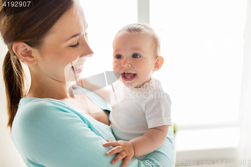 Image of happy young mother with little baby at home