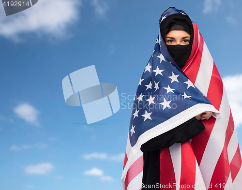 Image of muslim woman in hijab with american flag