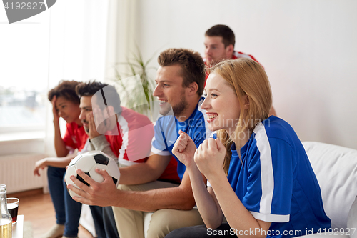 Image of friends or football fans watching soccer at home