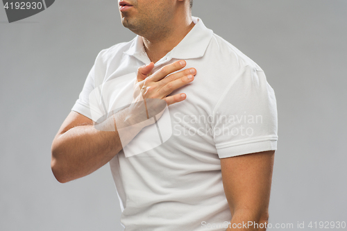 Image of close up of man with heart ache or chest pain