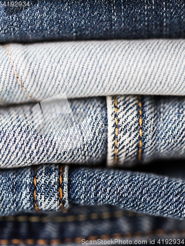 Image of close up of denim clothes or jeans pile