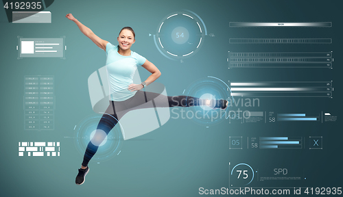 Image of happy smiling sporty young woman jumping in air