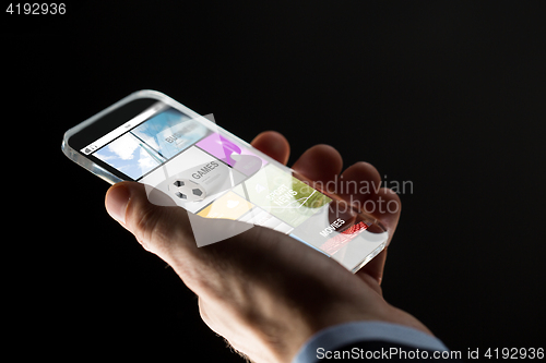 Image of close up of hand with apps on smartphone
