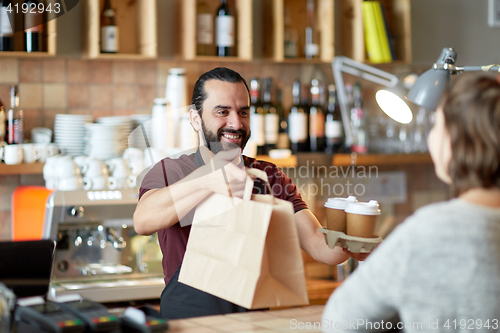 Image of man or waiter serving customer at coffee shop