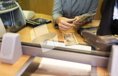 Image of clerk counting cash money at bank office