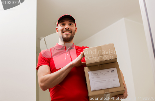 Image of delivery man with parcel boxes at customer door