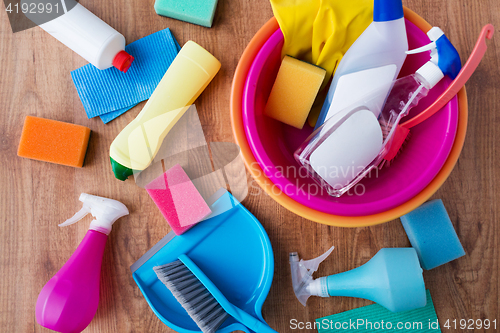 Image of basin with cleaning stuff on wooden floor