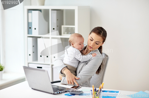 Image of businesswoman with baby and smartphone at office