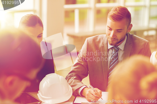 Image of architects with helmet and clipboard at office