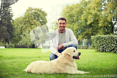 Image of happy man with labrador dog walking in city