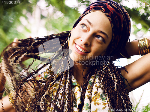 Image of Young cute smiling real stylish dressed woman in green palm park smiling, resting, enjoing, lifestyle outside concept