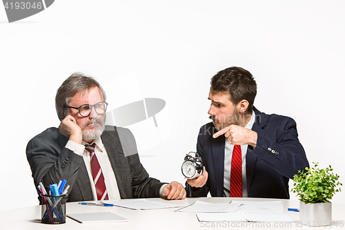 Image of The two colleagues working together at office on white background.