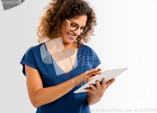 Image of Happy woman working with a tablet