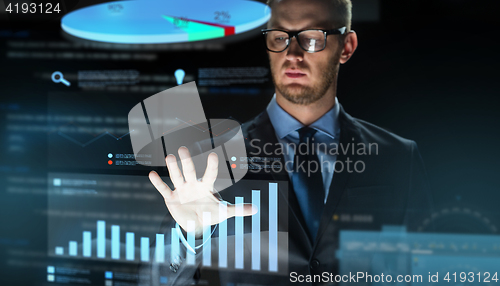 Image of businessman with virtual chart projection