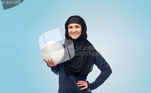 Image of happy muslim woman in hijab with volleyball