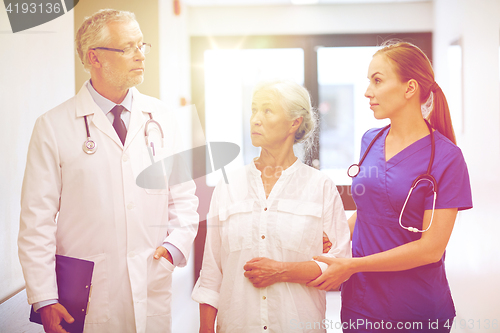 Image of medics and senior patient woman at hospital