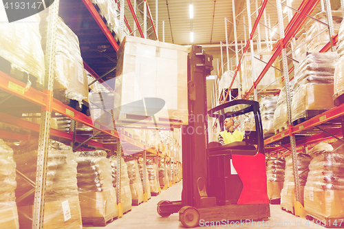 Image of man on forklift loading cargo at warehouse