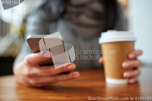 Image of close up of woman with smartphone and coffee