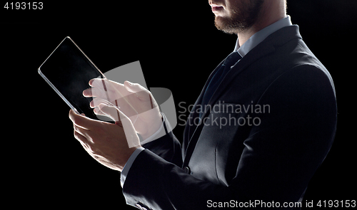 Image of close up of businessman with transparent tablet pc